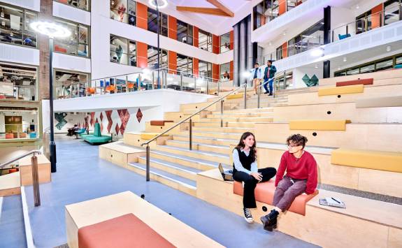 Two students chatting in the Stephenson Building atrium